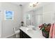 Bright bathroom featuring a single sink vanity, window, and shower-tub combo at 15501 E 112Th Ave # 6F, Commerce City, CO 80022