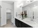 Modern bathroom featuring a double sink vanity, tiled floors, and a glass-enclosed shower at 15501 E 112Th Ave # 6F, Commerce City, CO 80022