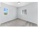 Bedroom featuring carpeted floors and two windows overlooking the neighborhood at 15501 E 112Th Ave # 6F, Commerce City, CO 80022