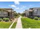 Beautiful community featuring manicured lawns, charming homes, and inviting walkways in a serene setting at 15501 E 112Th Ave # 6F, Commerce City, CO 80022