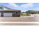 Townhome with a gray garage, stone accents, manicured landscaping, and inviting curb appeal at 15501 E 112Th Ave # 6F, Commerce City, CO 80022