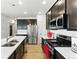 Well-equipped kitchen featuring stainless steel appliances, granite countertops, and dark wood cabinets at 15501 E 112Th Ave # 6F, Commerce City, CO 80022