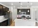 Modern kitchen with stainless steel appliances, center island, and sleek dark cabinetry providing ample space at 15501 E 112Th Ave # 6F, Commerce City, CO 80022