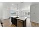 Open-concept living area with an island that connects to the kitchen, providing modern living at 15501 E 112Th Ave # 6F, Commerce City, CO 80022