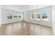Bright living room featuring hardwood floors, many windows and a modern chandelier at 15501 E 112Th Ave # 6F, Commerce City, CO 80022