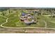 Aerial view featuring luxury homes set amidst rolling green hills, a pond, and walking trails at 8625 Eagle Moon Way, Parker, CO 80134