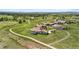 Aerial view of luxury homes nestled in a scenic landscape with lush greenery and winding paths at 8625 Eagle Moon Way, Parker, CO 80134