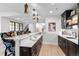 Basement bar featuring elegant marble counters, dark wood cabinets and stylish pendant lighting at 8625 Eagle Moon Way, Parker, CO 80134