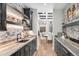 Stylish bar area with custom cabinetry, stone accents, and a convenient wine rack at 8625 Eagle Moon Way, Parker, CO 80134