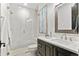 Bathroom with marble countertops, dark wood cabinets, and a sleek glass shower at 8625 Eagle Moon Way, Parker, CO 80134