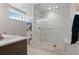Modern bathroom featuring a glass-enclosed shower with pebble floor and bench seat at 8625 Eagle Moon Way, Parker, CO 80134
