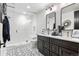 Modern bathroom featuring a walk-in shower, double sink vanity, and mosaic tile floors at 8625 Eagle Moon Way, Parker, CO 80134