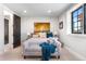 Bright bedroom featuring a bench at the end of the bed and art at 8625 Eagle Moon Way, Parker, CO 80134