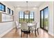 Dining room with large windows, hardwood floors, and a modern chandelier at 8625 Eagle Moon Way, Parker, CO 80134