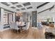 Elegant dining room featuring a coffered ceiling, hardwood floors, and designer lighting at 8625 Eagle Moon Way, Parker, CO 80134