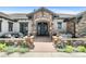 Inviting front porch with stone accents offers a relaxing outdoor seating area at 8625 Eagle Moon Way, Parker, CO 80134