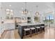 A modern kitchen with stainless steel appliances, marble countertops, and a large island with stool seating at 8625 Eagle Moon Way, Parker, CO 80134