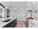 Bright, modern kitchen with a large island, white cabinets, stainless steel appliances and hardwood flooring at 8625 Eagle Moon Way, Parker, CO 80134