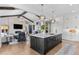 Spacious kitchen with dark island, marble countertop, stainless appliances, and open layout to the living area at 8625 Eagle Moon Way, Parker, CO 80134