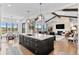 Open concept living room features a large kitchen island, comfortable seating, and natural light at 8625 Eagle Moon Way, Parker, CO 80134