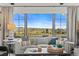 Bright living room featuring a comfortable sofa, stylish pillows and a large window with scenic views at 8625 Eagle Moon Way, Parker, CO 80134