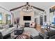 Cozy living room with a stone fireplace, wood beams, and an open layout at 8625 Eagle Moon Way, Parker, CO 80134