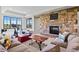 Cozy basement living room featuring a stone fireplace, comfortable seating and bright windows at 8625 Eagle Moon Way, Parker, CO 80134