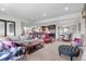 Spacious open-concept basement featuring a living area, bar, and dining space with natural light at 8625 Eagle Moon Way, Parker, CO 80134