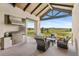 Outdoor kitchen and covered seating area with panoramic views of open space at 8625 Eagle Moon Way, Parker, CO 80134