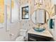 Stylish powder room featuring a blue glass bowl sink, decorative wall and a round gold-trimmed mirror at 8625 Eagle Moon Way, Parker, CO 80134
