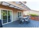 Outdoor dining on the back deck with a covered pergola, plus a sliding door to the home's interior at 4483 S Fundy St, Centennial, CO 80015