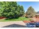 Lush backyard with mature trees, lawn, and patio area at 4483 S Fundy St, Centennial, CO 80015