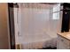 Bathroom featuring a tub-shower combo with white tile surround and updated fixtures at 4483 S Fundy St, Centennial, CO 80015