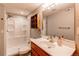 Bathroom with shower, toilet, vanity, sink, mirror and wooden storage box attached to wall at 4483 S Fundy St, Centennial, CO 80015