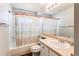Standard bathroom with large mirror, vanity and sink plus tub and shower with decorative curtain at 4483 S Fundy St, Centennial, CO 80015