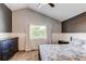 Vaulted ceilings, textured accent wall, and large window highlight this cozy bedroom at 4483 S Fundy St, Centennial, CO 80015