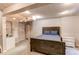 Basement bedroom with painted beams, carpet, sink and cabinets, plus bed with side tables at 4483 S Fundy St, Centennial, CO 80015