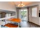 Cozy dining area with wood table and bench seating and sliding glass doors to the back deck at 4483 S Fundy St, Centennial, CO 80015