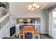 Bright dining area adjacent to the staircase has a wooden table and bench with views to the living room below at 4483 S Fundy St, Centennial, CO 80015
