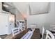 Dining room view showcasing natural light, neutral color scheme, and staircase at 4483 S Fundy St, Centennial, CO 80015