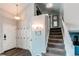 Open entryway with coat hooks leads to a carpeted staircase and upper level washer and dryer at 4483 S Fundy St, Centennial, CO 80015