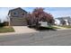 Charming two-story home with a well-maintained front yard and blossoming tree at 4483 S Fundy St, Centennial, CO 80015