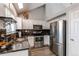 Stylish kitchen features stainless steel appliances, granite countertops, and sleek white cabinetry at 4483 S Fundy St, Centennial, CO 80015