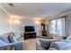 Cozy living room with a wood-burning stove, plush seating, and natural light from the window at 4483 S Fundy St, Centennial, CO 80015