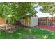 Backyard shed in a well-maintained yard with lawn and manicured mulch at 4483 S Fundy St, Centennial, CO 80015