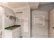Finished basement wet bar area with tile backsplash, sink, microwave and mini-refrigerator at 4483 S Fundy St, Centennial, CO 80015
