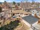Aerial view of the backyard with patio, separate garage, and stone pathway outside this brick home at 2576 Krameria St, Denver, CO 80207