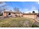 Well-kept lawn, patio with furniture outside this brick home, along with a separate garage structure in the backyard at 2576 Krameria St, Denver, CO 80207