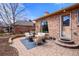 Cozy backyard with a brick patio, comfortable seating, and manicured landscaping at 2576 Krameria St, Denver, CO 80207
