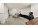 Basement living area with plush carpet, neutral walls, seating and a dark console, with a window for natural light at 2576 Krameria St, Denver, CO 80207